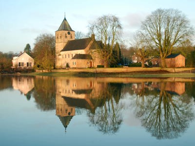 Old church of Oosterbeek, a Battle of Arnhem monument, reflected in the River Rhine